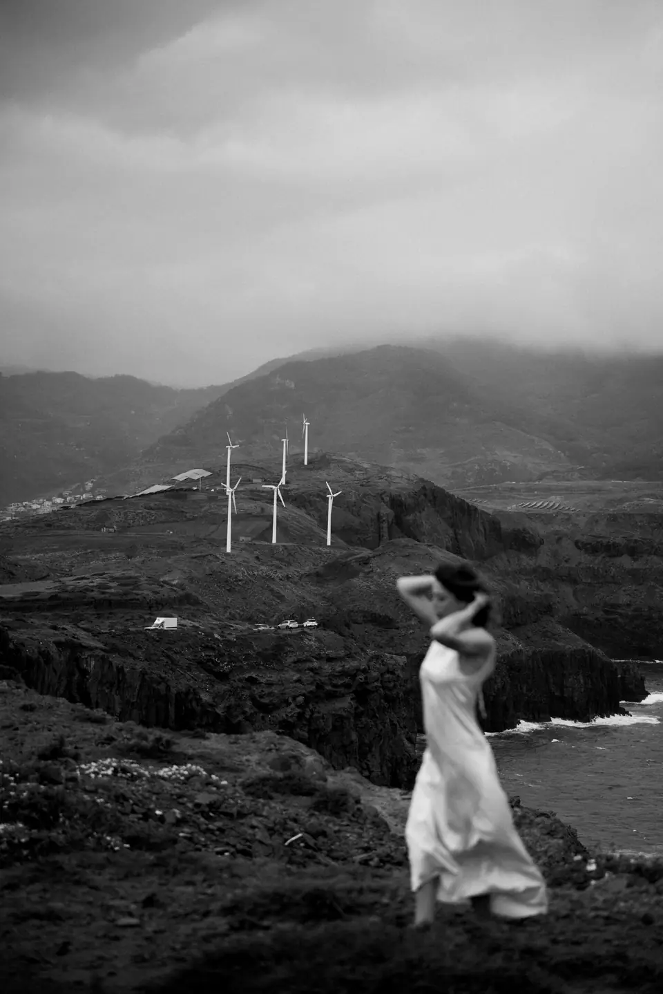 A woman in a white dress on the cliffs of São Lourenço, black and white — photo by Anna Belousova