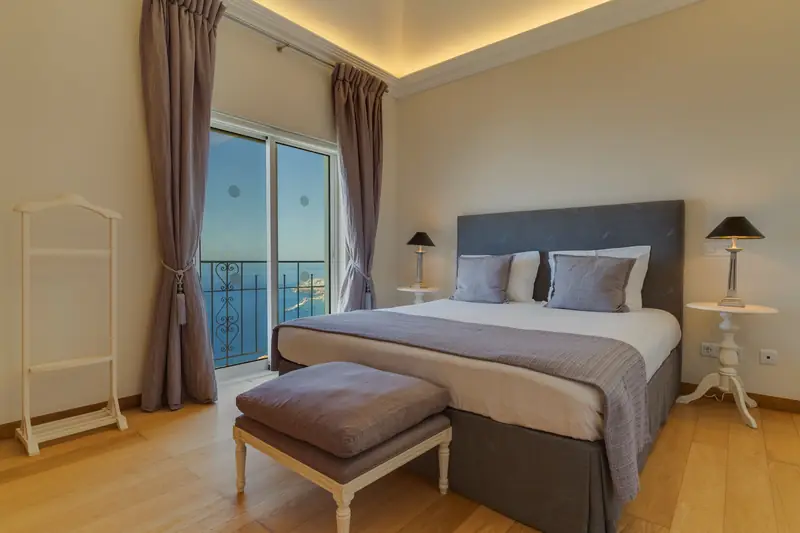 A bright villa bedroom with a view of the sea